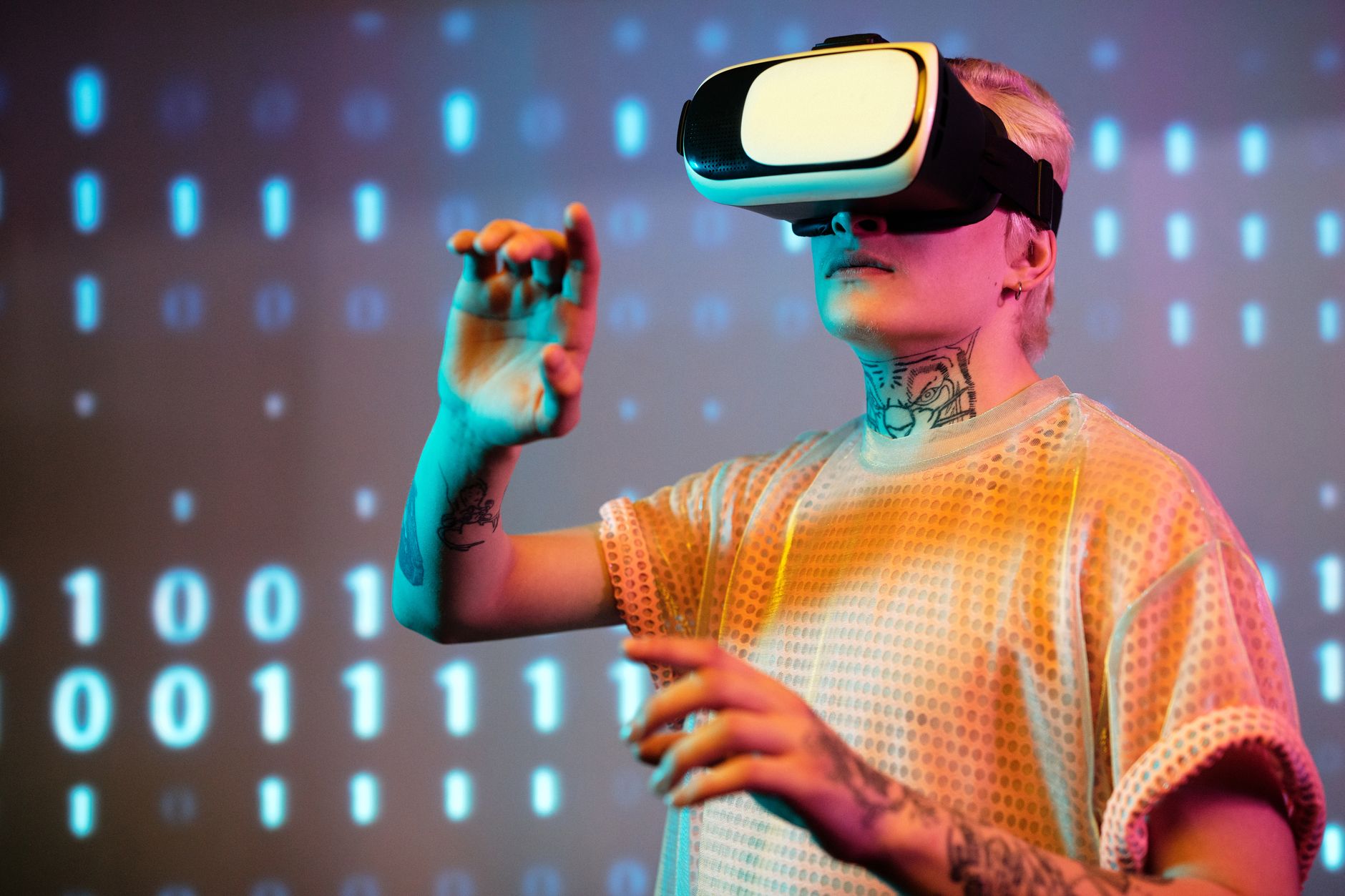 A young man interacts in virtual reality wearing a headset with a digital binary background. — Direct Access to Professional